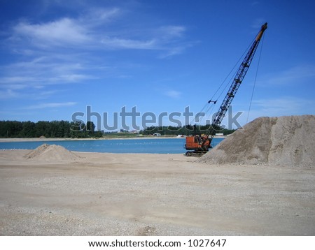 dragline pulling gravel out of water at gravel pit
