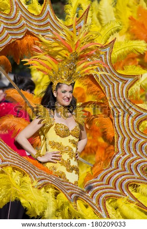 MENTON, FRANCE - 2 MARCH 2014 - Unidentified woman dressed as dancer marching during the parade of the Lemon Festival