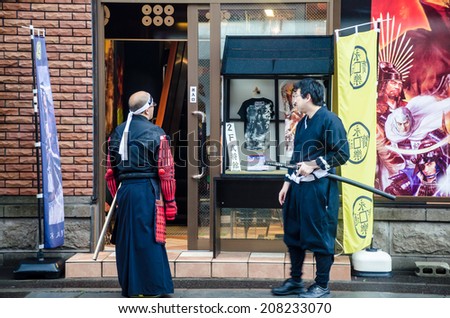 Otaru ,Japan -26 JULY 2014 :Two unidentified  wear the custume imitate cartoon character as ancient Japanese warrior  in Otaru town , Hokkaido, Japan