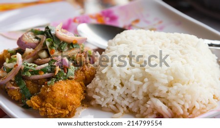 Rice served with Spicy Crispy chicken ,Thai fusion food style closeup with spoon