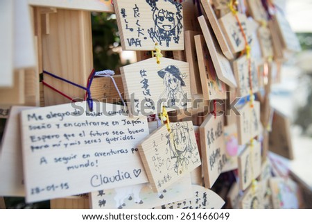 Asakusa , Japan  - February 4, 2015 :  
Wooden prayer hanging  boards with Japanese cartoon drawing in Japanese Shinto temple