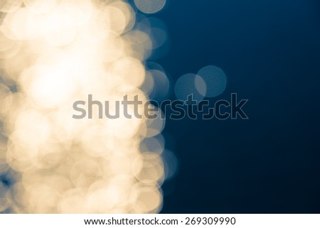 Defocused bokeh image in golden circle and blue background