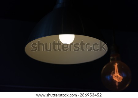 Hanged lamp in the dark room focus on big one