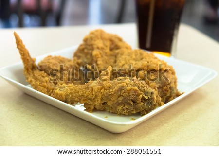 Fried chicken with cola drink closeup  focused on  leg part