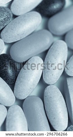 Multivitamin  tablets macro blue black and white vertical