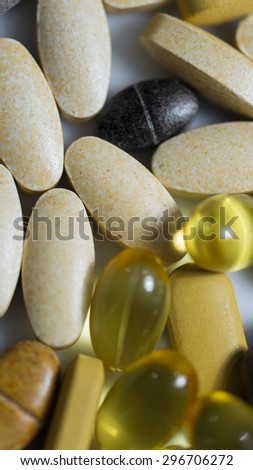 Multivitamin  and fish oil tablets  macro focused on vitamin tablets