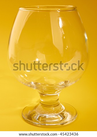 Empty wine glass isolated on yellow background
