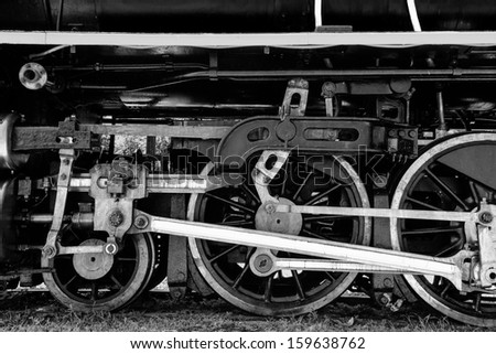 Black and white of Grunge antique steam train wheel