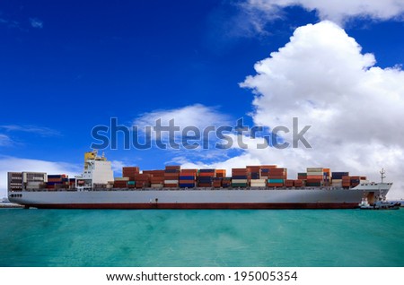 Cargo container ship at mediterranean coast with Blue sky