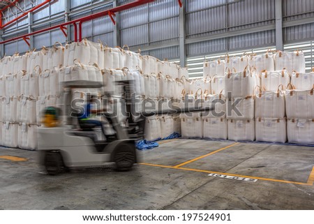 Forklift loader in warehouse with load jumbo bag