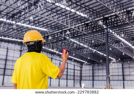 Foreman control working together at construction site of warehouse