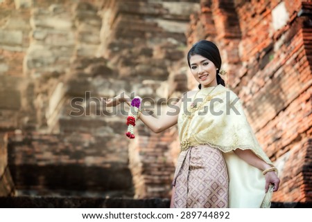 Female in Thailand traditional dress in Wat Mahathat at Ayuthaya historical park