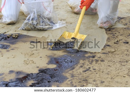 Spade excavate in dirty beach as tool to scoop crude oil on clean-up operation from crude oil spilled into Ao Prao Beach on July 31, 2013 in Rayong province, Thailand.