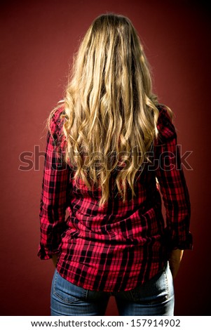 portrait of a middle aged woman back on a red background