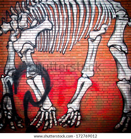 London-circa October 2013 : urban graffiti near Phipp Street. The work is a drawing of a dinosaur skeleton by an unknown artist