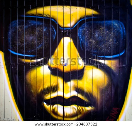 London, June 2014 - urban graffiti near Camden Lock Market. The work is a drawing portrait of man by an unknown artist