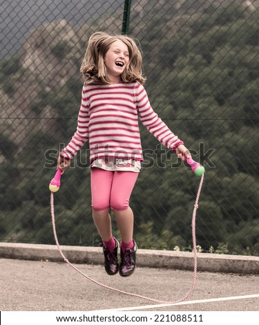 Portrait of a little girl jumping rope