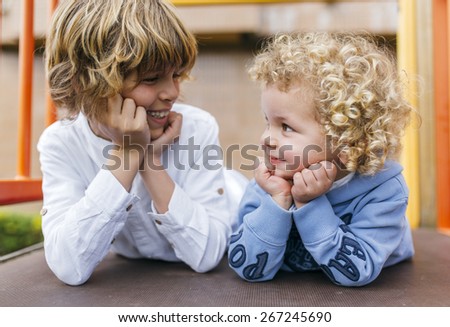 Portrait of two children blond brothers in the park