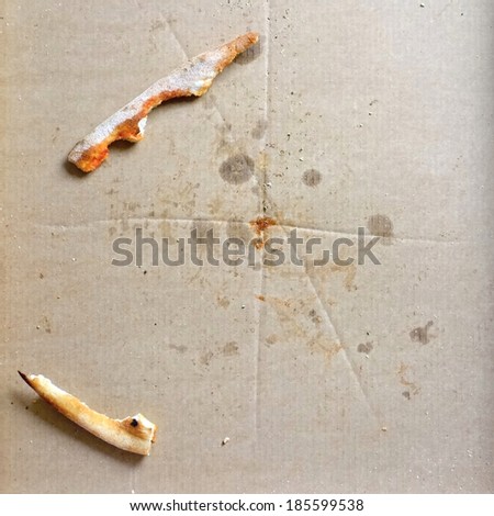 Remnants of pizza in a box