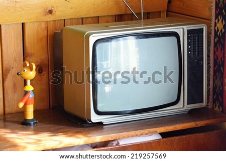 Old  tv. Retro style. Old household wooden background