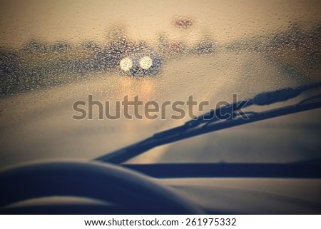 Driving from the driver\'s perspective in bad weather in the rain.