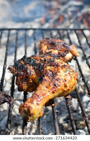 Chicken leg on the grill. Outdoor grilling on fire in nature