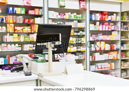 Cash desk - computer and monitor in a pharmacy. Interior of drug and vitamins shop. Medicines and vitamins for health and healthy lifestyle.