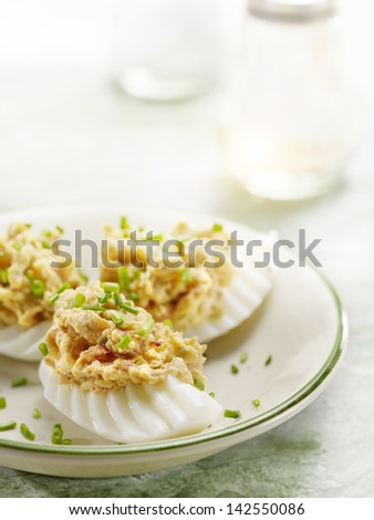 eggs stuffed with salad served on a plate