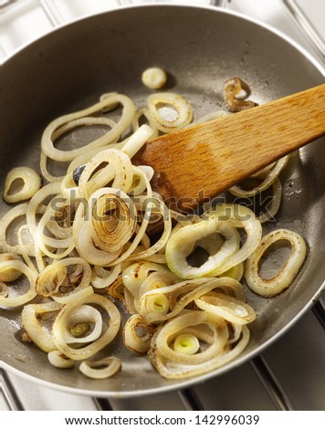 baking onion rings in frying pan on furnish