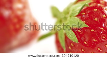extreme close up of a strawberry. one other strawberry unsharp in the background