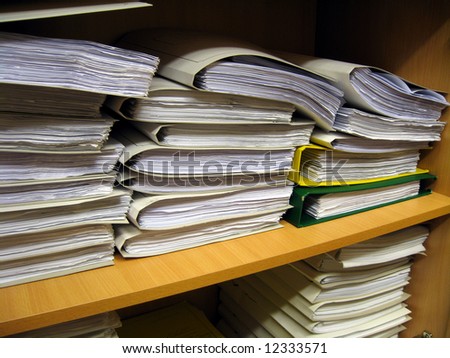 The office bookshelf with different documents, books and folders