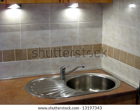 Stainless steel sink in the modern kitchen