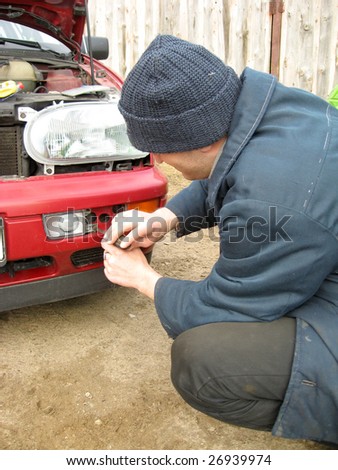 Man, repairing the car fog lights, outdoor