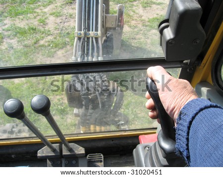 Excavator operating handles and joystick, close up