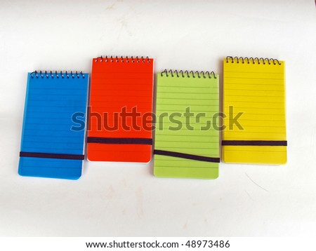 The set of four different color notebooks