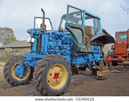 Tractor repairing outdoor, in the country yard