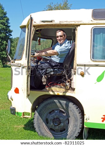 Senior man driving old vintage russian bus