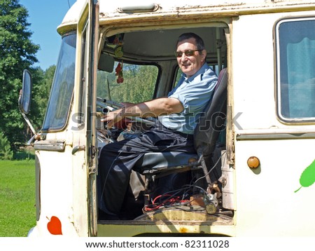Senior man driving old vintage russian bus