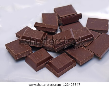 Stack of chocolate pieces on the white background