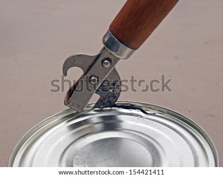 Opening metal can with preserved food by old can opener