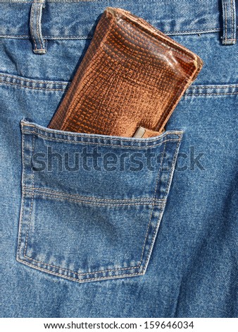 Brown wallet in jeans trousers back pocket