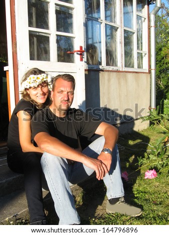 Young man and woman sitting couple on midsummer day