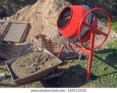 Mobile electric cement mixer and wheelbarrow with cement mortar