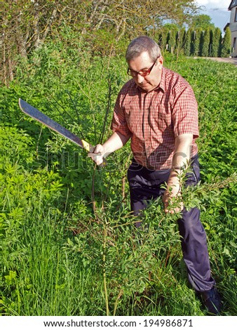 Senior country farmer cut the bush with machete