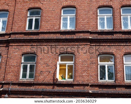 Rows of windows on old red brick house wall