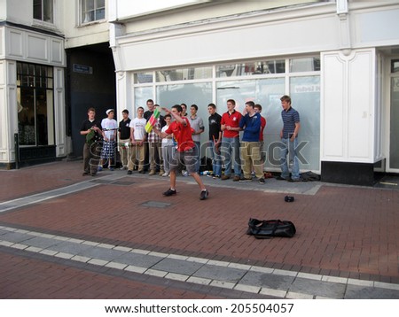 DUBLIN, IRELAND - MAY 25, 2010: Young street artists show their performances to earn some money.