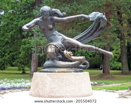 PALANGA, LITHUANIA - AUGUST 12, 2009: Bronze statue of woman and snake is located in town park.