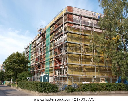 LIEPAJA, LATVIA - SEPTEMBER 8, 2014: Workers are heating apartment house walls with stone wool plates.