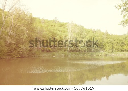 river landscape with sunset against ripple water - vintage retro