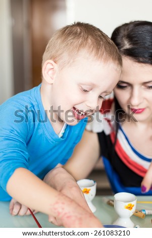 Mom and Son Painting eggs for Easter holiday celebration